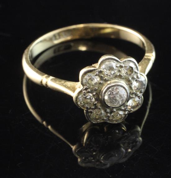 A 1940s 18ct gold and diamond cluster ring, size M.